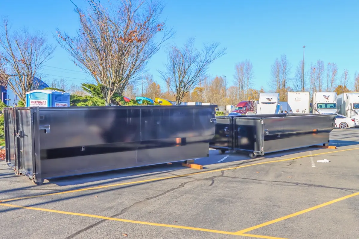 Professional dumpster rental service with roll-off container on residential driveway in Sylvania